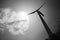 Wind turbine against sky in black and white. Wind power plant clean enegy