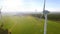 Wind turbine and agricultural fields on a summer day