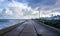 Wind turbine behind manufacturing plant on the coast at Lowestoft, Suffolk, UK