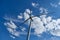 Wind turbine on blue sky background, ecological power.