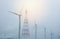 Wind turbine blur That produce electrical power And high voltage transmission towers