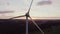 Wind turbine in the bright rays of the rising sun, bird\'s eye view