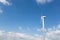 Wind turbine for clean energy production in front of blue sky