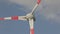 Wind turbine close-up against the background of clouds floating in the sky. Rotation of large wind turbine blades