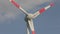 Wind turbine close-up against the background of clouds floating in the sky. Rotation of large wind turbine blades