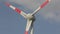 Wind turbine close-up against the background of clouds floating in the sky. Rotation of large wind turbine blades close