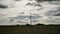 Wind turbine with a cloudy and gray sky