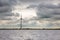 Wind turbine at Dutch coast with threatening dark sky
