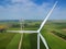 Wind Turbine Farm In Green Field - Green Energy