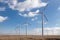 Wind turbine farm over the blue cloudy sky