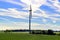 Wind turbine in the field. Wind generator. Blue sky.