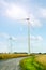 Wind turbine generators in a field against sky