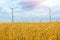 Wind turbine among golden ears of grain crops