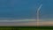 Wind turbine in a green field in the hills of pure nature.