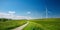 wind turbine park in green meadow against blue sky, clean renewable and sustainable energy. banner with copy space