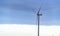 Wind turbine shot against a dark stormy skyline