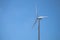 Wind turbine is standing tall in blue sky, Wind energy. Wind power. Sustainable, renewable energy. Wind turbine generate