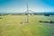 Wind turbine standing tall in harsh sunlight.