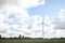 Wind turbine in a sunny day with blue sky and clouds. Wind farm eco field. Green ecological power