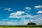 Wind turbine surrounded by green fields