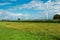 Wind turbine surrounded by green fields