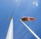 Wind turbine and windbag against blue sky
