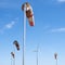 Wind turbine and windbag as silhouette against blue sky