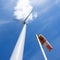 Wind turbine and windbag and white cloudagainst blue sky