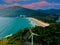 wind turbine windmill, at sunset Naiharn Patong Beach, oceans islands mountains in the beautiful resort island of Phuket Thailand