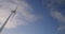 Wind turbine windmill turning in a blue sky with clouds