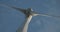 Wind turbine windmill turning in a blue sky with clouds