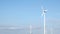 Wind turbines against bright blue sky
