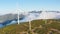 Wind turbines in a beautiful sunny place in the mountains in autumn. Green energy production. Wind farm in an ecological field.