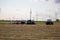 A Wind turbines behind farmers farming there field Nebraska