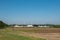 Wind turbines behind a new building settlement in rural surround