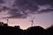 Wind turbines during dusk with clouds