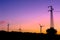 Wind turbines and electricity pylons silhouettes