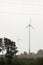 Wind turbines field in a stormy day with strong wind and rain. Wind farm eco field. Green ecological power