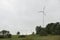 Wind turbines field in a stormy day with strong wind and rain. Wind farm eco field. Green ecological power