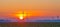 Wind turbines in a field at sunrise