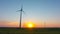 Wind turbines in the field and sunset, long time-lapse