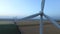 Wind turbines in fields near the sea driven with the sea breeze. Aerial survey. Close up