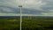 Wind turbines on forest on cloudy day