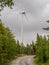Wind turbines in the forest with rainy sky. Ecological power concept