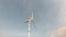 Wind turbines generate electricity That is work rotation Background clouds