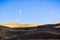 Wind turbines on the golden hills of east San Francisco bay area; burnt grass in the foreground; Altamont Pass, Livermore,