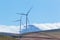 Wind turbines with mountains and clouds in the background