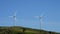 Wind turbines in the mountains moving with blue sky