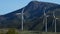 Wind turbines in the mountains moving with blue sky