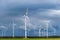 Wind turbines in open terrain on windy days with dark clouds in the sky